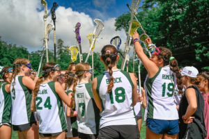 Girls playing lacrosse at summer camp