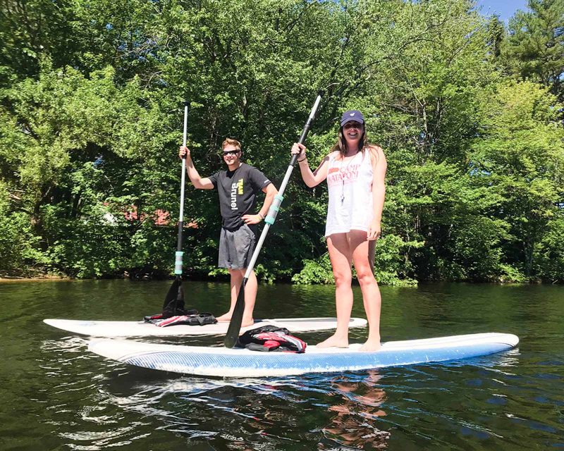 Mataponi staff members on stand-up paddleboards