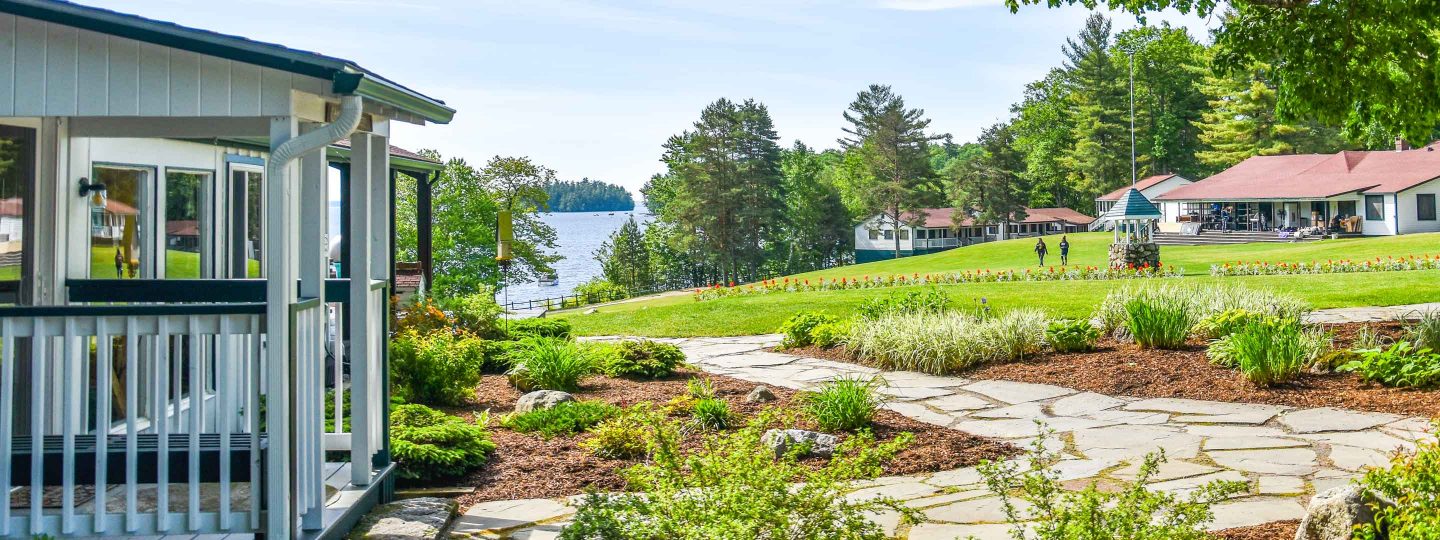 Camp cabin with cobblestone path overlooking lake