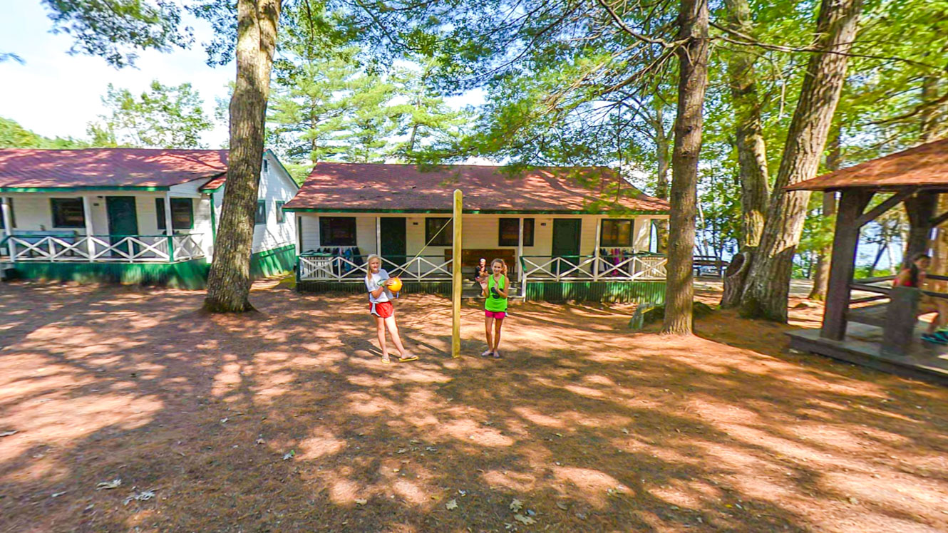 Campers play outside a Mataponi cabin